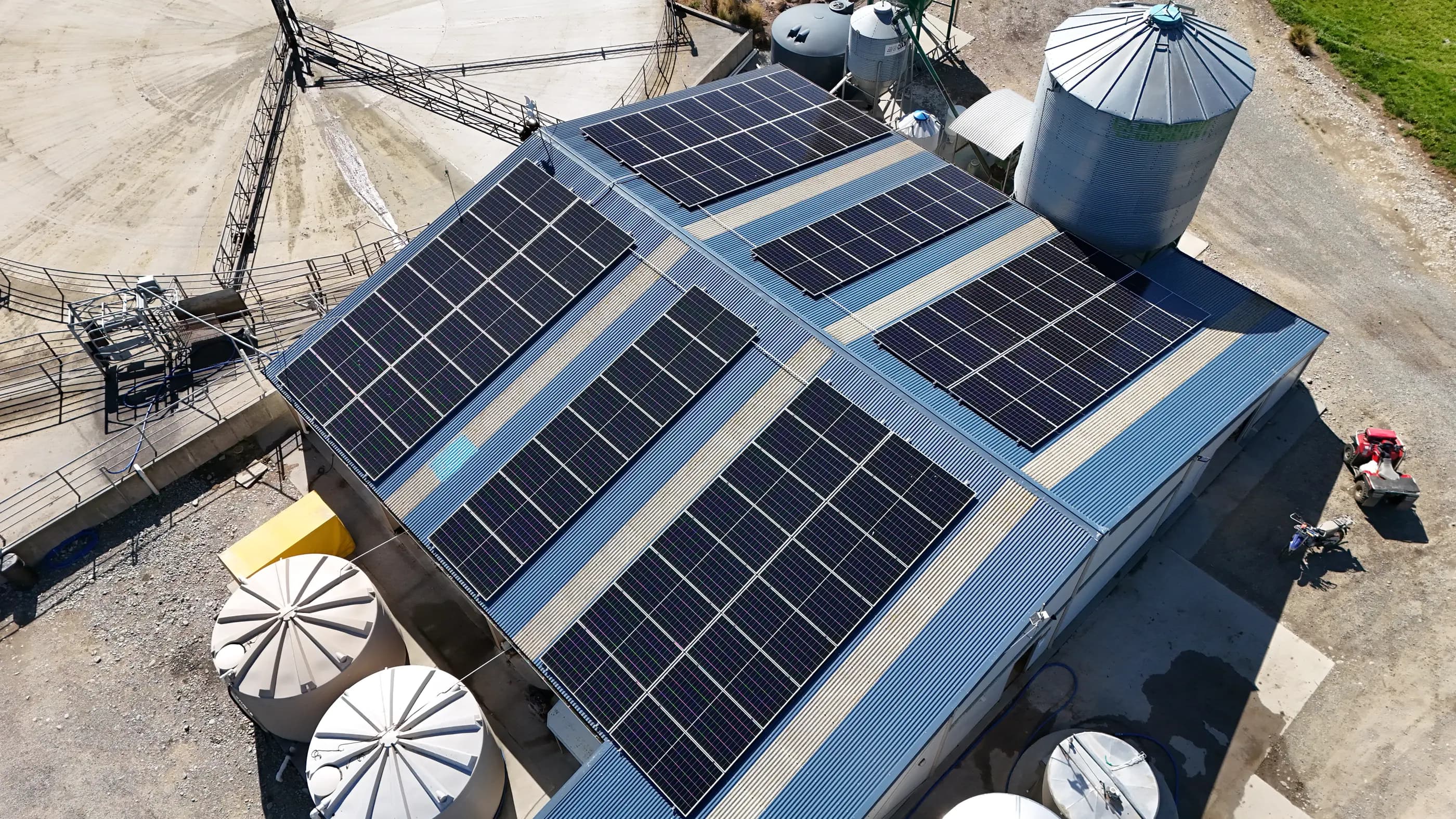 Aerial view of a large solar array across a working commercial site on Frisbys Drive